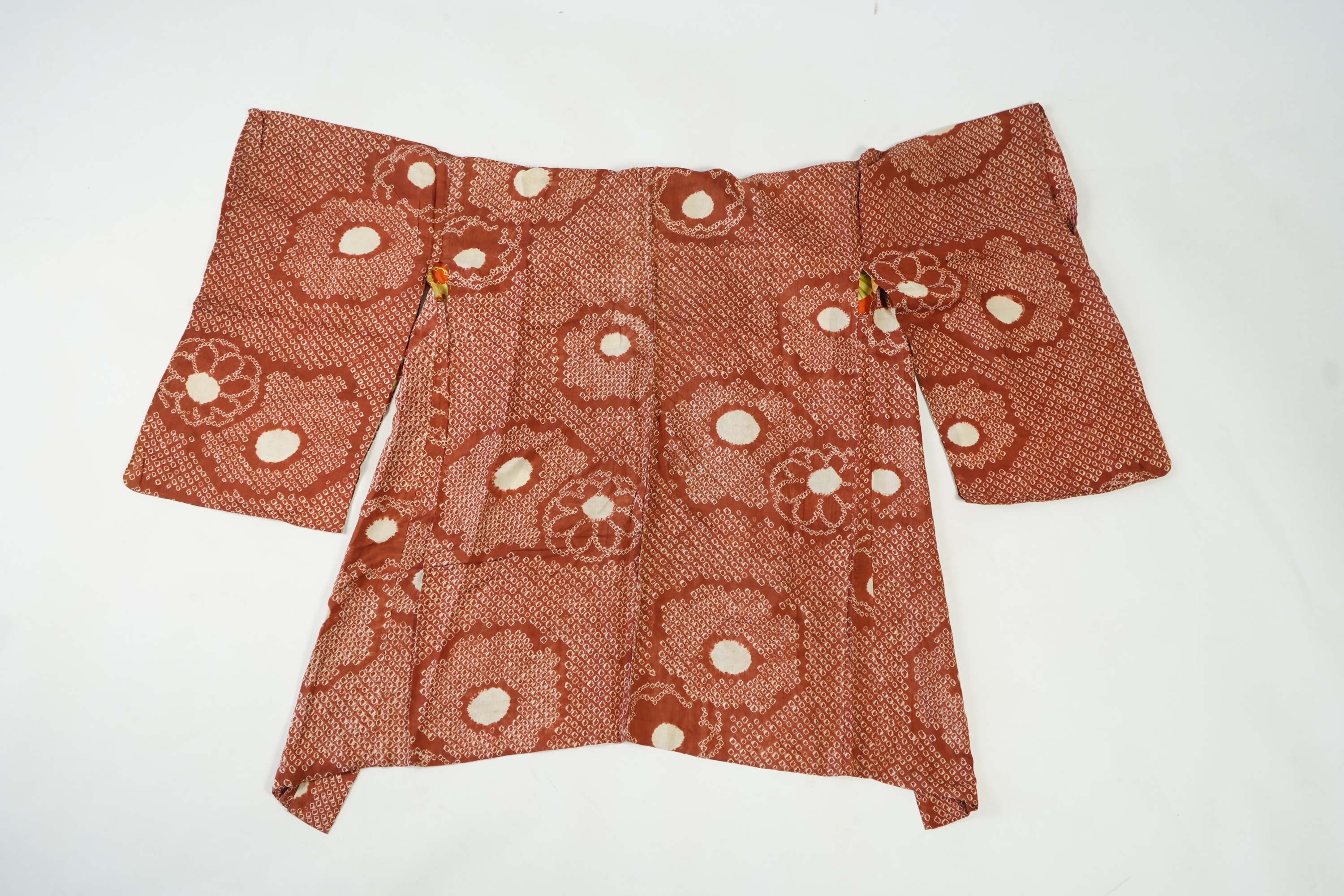 Three Japanese mid 20th century ‘Haori’ printed silk jackets. One red with brightly coloured lining and rust brown floral silk lining. All with large kimono sleeves. Grey patterned Haori, 79cm long., Condition - good